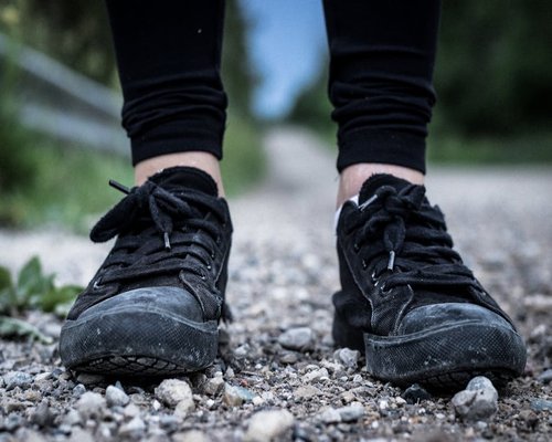 Close up of comfortable shoes walking on a paved pathway