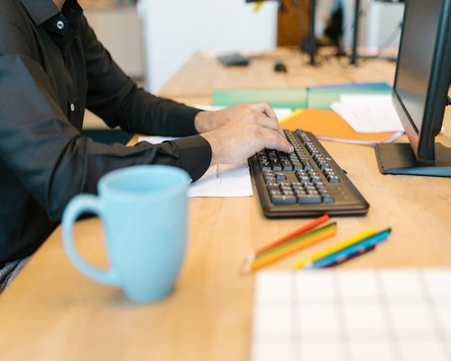 Person working at a modern office desk with good posture