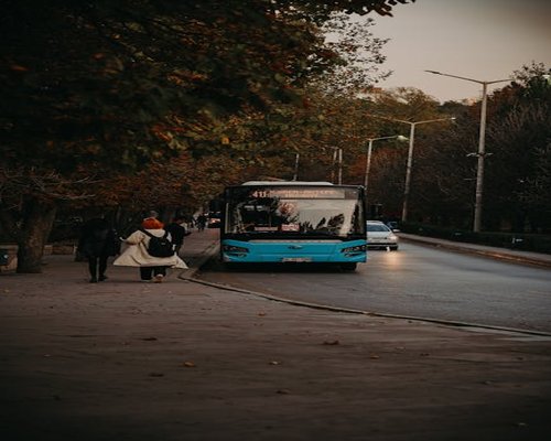 People walking at a bus station in the city